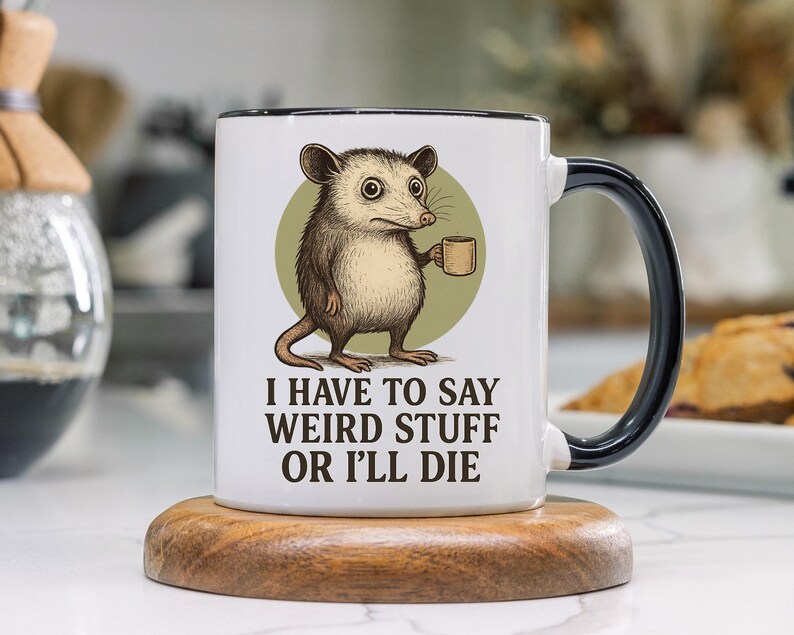 Funny possum mug featuring a cartoon possum holding a cup with a weird stuff quote; quirky office humor mug, coworker gift.