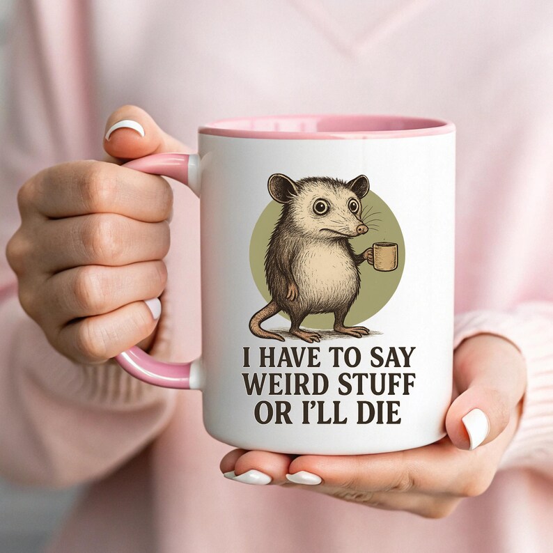 Funny possum mug featuring a cartoon possum holding a cup with a weird stuff quote; quirky office humor mug, coworker gift.
