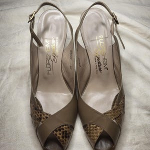 May include: A pair of taupe slingback heels with a peep-toe design and snakeskin-textured accents on the front. The interior insoles feature the text Florsheim Signature and Made in Hong Kong. The shoes include adjustable ankle straps with buckles.