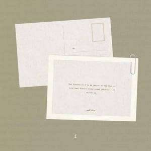 May include: Two white postcards on a neutral background. One postcard is blank, while the other has printed text and is held together with a silver paperclip. The text reads: "How blessed am I to be shaped by the kind of love that doesn't break under pressure - it builds us."