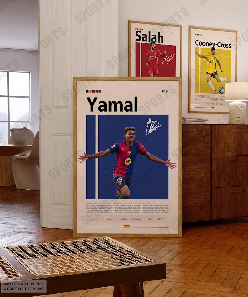 May include: A framed vertical sports poster featuring a photograph of a soccer player in a blue and red jersey with the name Yamal printed in large black letters at the top, accompanied by a white signature and descriptive text blocks below.