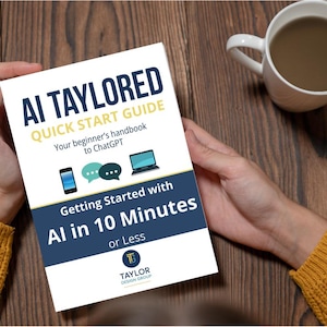 May include: A white book titled "AI Tailored Quick Start Guide" held by a person. The book's cover includes the text "Getting Started with AI in 10 Minutes or Less" and illustrations of a phone, chat bubbles, and a laptop. A mug of coffee sits nearby.