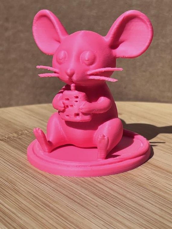 Pink mouse eating cheese