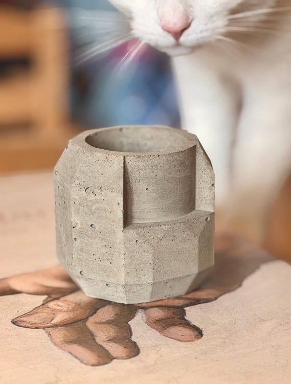 Hand-cast concrete in a sharp octagonal architectural mold hits the brutalist-home-decor sweet spot — heavy, tactile, and looks like it belongs in a design museum.