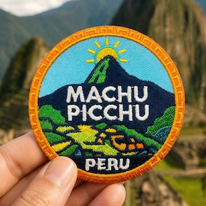 May include: A circular embroidered patch featuring a dark blue mountain silhouette against a light blue sky with a yellow sun. The text reads MACHU PICCHU in white, with PERU below. The border is orange with a repeating geometric pattern.