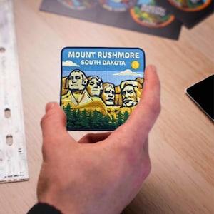 May include: A set of three ceramic mugs with a speckled, matte finish. The mugs are in shades of cream, light gray, and dark gray. Each mug has a simple, minimalist design, perfect for coffee or tea.