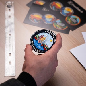 May include: A handmade wooden chopping board with a natural finish. The rectangular board has a juice groove and a handle with a hanging hole. The wood grain is visible, demonstrating the board's craftsmanship.