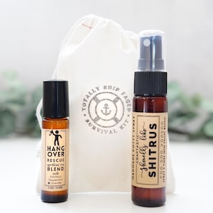 May include: A set of two small bottles with labels. The first bottle is a brown glass roll-on bottle with a black cap and a label that reads "Hangover Rescue Essential Oil Blend with Patchouli, Peppermint + Lavender 0.33oz/10.38ml". The second bottle is a brown glass spray bottle with a black cap and a label that reads "Handmade Potty Spray Craptactic Shmells Like Shitrus Doo Doo Voodoo Spray 3 Times Into Toilet Bowl".