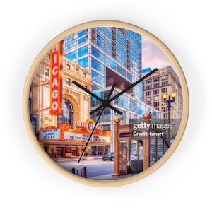 Könnte beinhalten: Runde Wanduhr mit einem Foto des Chicago Theatre. Das Zifferblatt zeigt das Chicago Theatre-Schild und die umliegenden Gebäude. Die Uhr hat einen beigefarbenen Holzrahmen und schwarze Zeiger.