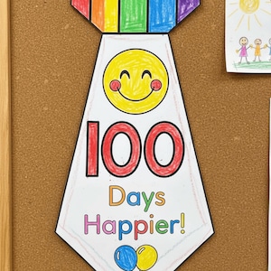 May include: A colorful paper tie pinned to a corkboard, celebrating "100 Days Happier!" The tie features a rainbow top, a smiling yellow face, and the number "100" in red. Two balloons are at the bottom. A drawing of a sun and children is also pinned.