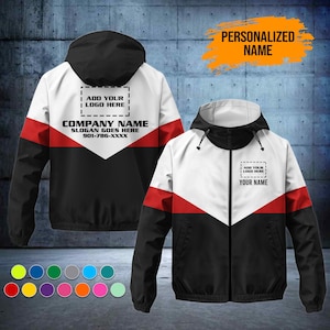 May include: A color-blocked zip-up hooded jacket featuring white, red, and black panels. The back displays text reading ADD YOUR LOGO HERE, COMPANY NAME, SLOGAN GOES HERE, and 901-786-XXXX. The front shows ADD YOUR LOGO HERE and YOUR NAME.