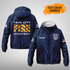 May include: Navy blue hooded jacket with white lining. The back displays "YOUR CITY FIRE DEPARTMENT" in yellow and red lettering. The front has a white badge and "YOUR NAME" text. Includes an American flag patch.