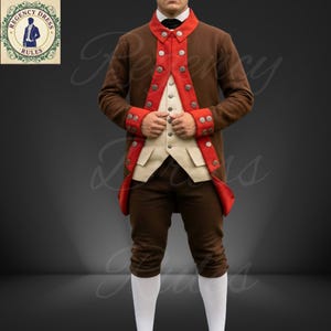 May include: A brown historical costume with red trim and silver buttons. The outfit includes a jacket, vest, and breeches. The jacket has red cuffs and collar. The vest is cream-colored, and the breeches are brown. White stockings complete the look. The logo on the upper left says "Regency Dress Rules".