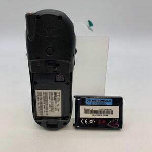 May include: A black Motorola cell phone with a detached battery. The phone has a Motorola logo and various labels with text. The battery is black with the Motorola logo and text including "SNN5671A" and "CELL ORIGIN CHINA".