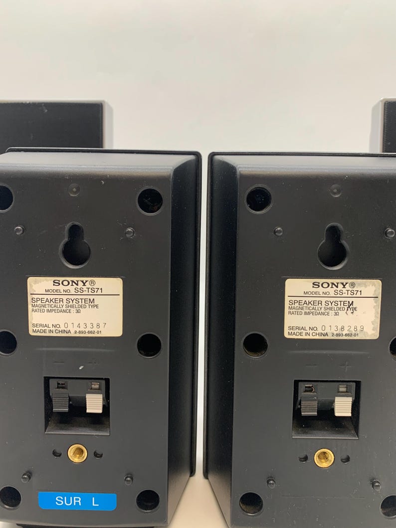 May include: Two black Sony speaker system units, model SS-TS71, featuring a magnetically shielded design with a rated impedance of 3 ohms. Each unit includes a wall-mount keyhole, a spring-clip wire terminal, a threaded insert, and a blue label.