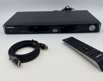 Reproductor de DVD Samsung DVD-HD870 vintage de la década de 2000, HDMI 1080i, probado y funcionando, con control remoto y cable HDMI.