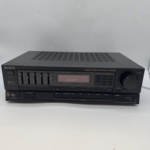 May include: Black Sony audio/video control centre with a digital display showing "69.0". The unit has multiple buttons, a volume knob, and an equaliser with sliding controls. The word "SONY" is visible on the left side.