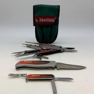 May include: A set of Sheffield stainless steel multi-tools and a green carrying case. The tools include knives, scissors, and pliers. The Sheffield logo is visible on the tools and case.
