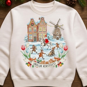 May include: White sweatshirt with a winter scene featuring a windmill, houses, and children ice skating. Santa Claus rides a white horse. The words "Vrolijk Kerstfeest" are on a banner.