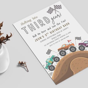 May include: A white invitation with the text "Shifting Into THIRD gear!" and "JSON'S 3RD BIRTHDAY BASH". The invitation features illustrations of monster trucks racing on a dirt track, with checkered flags.