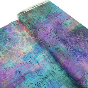 May include: A bolt of fabric featuring a purple and teal watercolor background with a damask pattern overlay. The print includes vintage French script, handwritten numbers, and the text C. RIFFARD SUCCURSALES, MAISON, and PARIS.