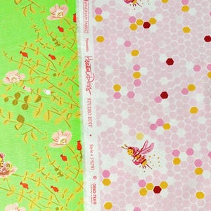 May include: Two fabric panels with floral and bee patterns. One panel is light green with pink flowers and bees. The other is pink with a honeycomb design and bees. The text "Heather Ross STUDIO EDIT" is visible.