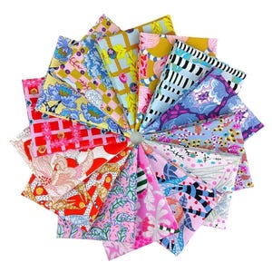 May include: A circular arrangement of colorful fabric squares, each with a unique floral or geometric pattern. The fabrics feature a variety of colors, including pink, blue, yellow, and red. The arrangement is set against a white background.