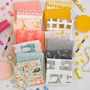May include: An overhead shot of a collection of folded fabric squares in various colors and patterns, including pink, yellow, and blue. Sewing notions like scissors, thread, and buttons are scattered around the fabric, suggesting a crafting theme.