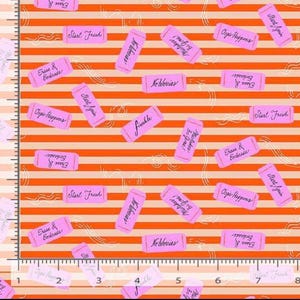 May include: Fabric featuring a pattern of pink rectangular erasers on an orange and light orange striped background. The erasers display text including Start Fresh, No Worries, Oops Happens, Erase & Embrace, and Mistakes Be Gone. A ruler shows 8 inches.