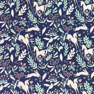 May include: Dark blue fabric with a repeating pattern of white unicorns, rabbits, birds, and floral elements in pink and light green. The fabric has the text "Magic" and "Michael Miller Fabrics" on the side.