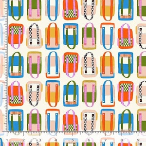 May include: A cream-colored fabric featuring a repeating pattern of colorful tote bags in shades of blue, orange, green, and pink, with various strap designs. A ruler showing 9 inches is visible along the left edge and 10 inches at the bottom.