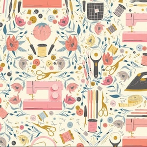 May include: A repeating pattern featuring sewing tools and floral elements. Pink sewing machines, scissors, spools of thread, buttons, and flowers are scattered across a cream-colored background. The design includes gold, blue, and gray accents.
