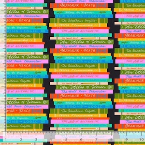 May include: A black fabric featuring a repeating pattern of stacked books with colorful spines and titles like The Hall Pass Chronicles, Grammar & Grace, and An Atlas of Wonder. A ruler showing 10 inches is visible along the bottom and left edges.