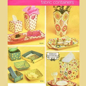 May include: Simplicity fabric container pattern featuring various sizes and shapes. Includes a tissue box, vase, trays, and small containers. The containers have floral and geometric patterns in yellow, pink, and green.