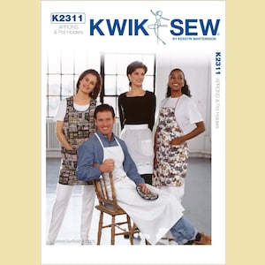 May include: Kwik Sew pattern cover featuring aprons and pot holders. The cover displays four people wearing different apron styles. The aprons have various patterns, including a cityscape and floral designs. The Kwik Sew logo and pattern number K2311 are visible.