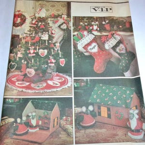 May include: A vintage sewing pattern sheet by V.I.P. featuring Christmas decorations including a decorated tree, stockings with lace trim and the name Megan, and fabric mouse figures dressed in Santa outfits displayed with a small fabric house.