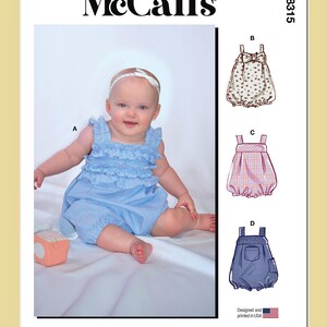 May include: McCall's M8315 sewing pattern envelope featuring a baby wearing a blue and white striped ruffled romper. The pattern includes illustrations for four variations labeled A, B, C, and D, showcasing different fabric prints, bows, and pocket details.