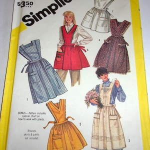 May include: Simplicity sewing pattern 6173 for size 18-20 misses. The envelope features illustrations of five different apron styles, including plaid, solid red, floral, and plain designs with pockets, ties, and various necklines.