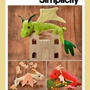 May include: Simplicity pattern S9363 features plush dragon toys in green, white, and red. The green dragon rests on a wooden castle. The pattern includes instructions for making various dragon designs with wings and horns.