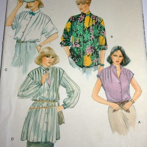 May include: An illustration of four different blouses. The blouses are in various styles and colors, including a light purple, green with floral patterns, and a striped design. The image is a vintage fashion illustration.