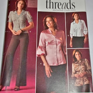 May include: Simplicity Threads magazine cover featuring sewing patterns for blouses and pants. The cover includes images of the finished garments, showcasing various styles and designs. The text reads "Step by step to sewing success!"