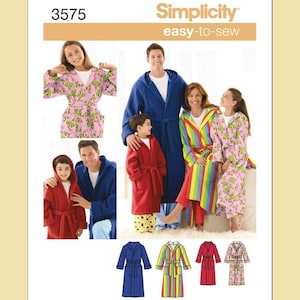 May include: Simplicity 3575 easy-to-sew sewing pattern for hooded robes. The pattern features four variations: a solid blue robe, a solid red robe, a multi-colored vertical striped robe, and a pink robe with a green frog print pattern.