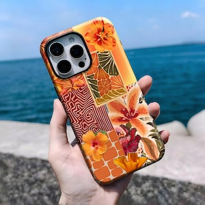 May include: A vibrant phone case with a patchwork design. It features floral and geometric patterns in orange, red, and yellow. The case has a glossy finish and a camera cutout.