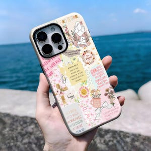 May include: A phone case with a collage design featuring floral elements, inspirational quotes, and the text "GOD IS GOOD". The case has a cream-coloured border and a mix of pink, white, and beige backgrounds.