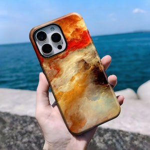 Puede incluir: Funda de teléfono inteligente con un diseño abstracto vibrante que se asemeja a una puesta de sol o un paisaje de nubes. La funda presenta una mezcla de colores cálidos, incluyendo naranja, rojo y amarillo, con un toque de azul. Acabado brillante.