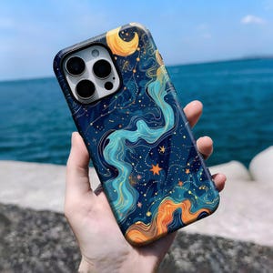 May include: A smartphone case with a celestial design. The case features a dark blue background with swirling teal and orange patterns, gold stars, and a crescent moon. The case has a glossy finish.