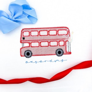 May include: A red and white double-decker bus design on a white background. The bus has black wheels and is embroidered with a checkered pattern. The word "oxfordms" is written in blue script below the bus. A light blue bow and red ribbon are also in the image.