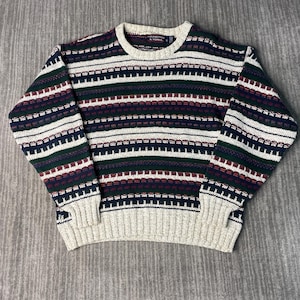 May include: A vintage crew neck sweater with a striped pattern in navy, green, burgundy, and white. The sweater has a beige collar, cuffs, and hem. The brand name "Youngtree & Yorke" is visible on the collar.