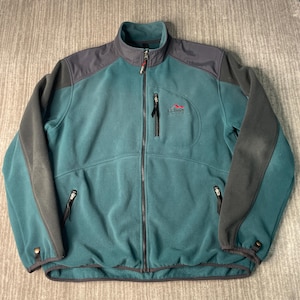 May include: Teal and gray fleece jacket with a full zipper closure. The jacket features a high collar, two zippered pockets, and the L.L.Bean logo on the chest. The sleeves and shoulders are gray, and the body is teal.