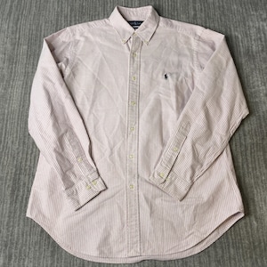 May include: A button-down shirt with long sleeves, featuring a pink and white striped pattern. The shirt has a button-down collar and a small embroidered logo on the chest. The shirt is made of a lightweight fabric.